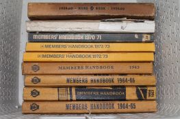 A box containing nine mid twentieth century AA members handbooks