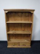 A set of pine wall shelves fitted two drawers