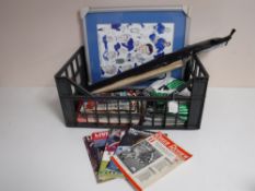 A crate containing assorted match day programmes, Sunderland, Newcastle, a framed Everton print,