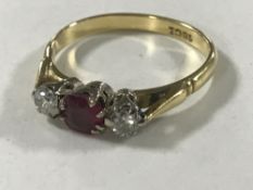 An 18ct gold ruby and two stone diamond ring, size O/P, 3.3g.