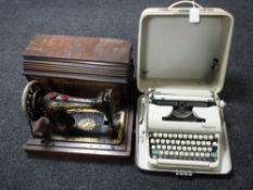 A cased Olympia typewriter and a mahogany cased Singer sewing machine