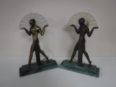 A pair of Art Deco figural table lamps on marble bases with glass fan shades