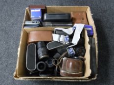 A box containing assorted cameras, lenses,