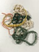 A group of five necklaces to include a large pearl example, jade, coral,