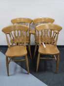 A set of four pine kitchen chairs comprising two carvers and two singles