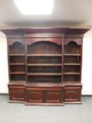 An impressive reproduction mahogany break fronted bookcase,