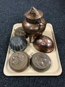 A copper lidded cauldron on three legs,