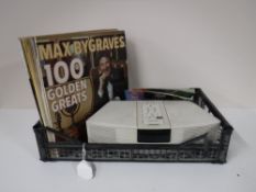 A basket containing a Bose wave radio together with a small quantity of LP's and six 1970's