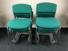 A set of eight metal framed stacking chairs upholstered ina green fabric