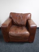 A brown leather Delcor armchair