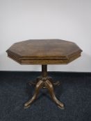 An early 20th century octagonal oak pedestal table
