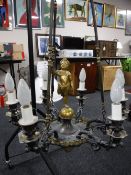 A continental metal six branch chandelier surmounted with a cherub