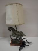 An early 20th century figural table lamp of a horse on marble base with shade