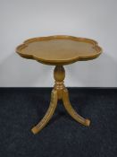 A pine shaped top occasional table on a carved pedestal