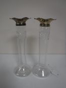 A pair of early 20th century glass vases with silver rims,