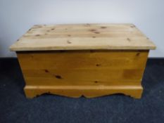 A stripped pine blanket chest