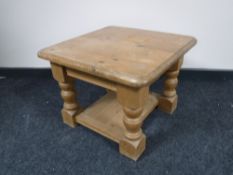 A pine two-tier lamp table