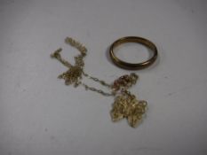 A 9ct gold band together with a 9ct gold necklace with pendant