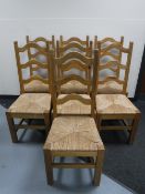 A set of seven pine rush seated dining chairs CONDITION REPORT: Some joints a little