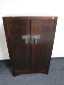 An Oriental stained pine double door cabinet