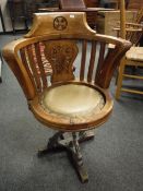 An early twentieth century DFDS ship's walnut carved swivel armchair