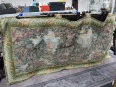 A large hanging tapestry on brass pole depicting a garden scene