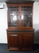 A Victorian mahogany double door bookcase fitted cupboards beneath