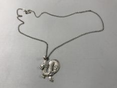 A sterling silver Chinese dragon pendant on silver chain