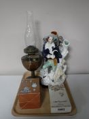 A tray of two Staffordshire figures, oil lamp,