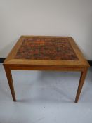 A teak nest of four tables and a teak tiled topped coffee table
