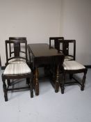 An oak gate leg table and four chairs