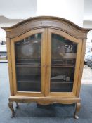 A continental oak domed topped double door display cabinet