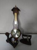 A contemporary barometer together with a cobbler's last and a flat iron