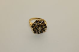 An 18ct gold sapphire and diamond cluster ring, 7.