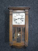 An oak cased 8 day wall clock with silvered dial
