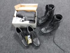 A box containing two pairs of safety shoes and a pair of safety boots