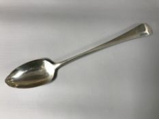 A Georgian silver serving spoon, London 1803.