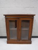 A Victorian mahogany double door bookcase together with an antique pine towel rail