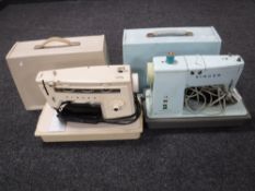Two cased Singer electric sewing machines