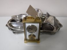 A brass German carriage clock, together with a plated gallery tray, plated candle holders,