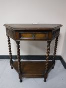 A shaped oak hall table on barley twist legs