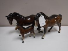 Two Beswick horses (front foot raised,