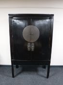 An Oriental lacquered double door cabinet CONDITION REPORT: This measures 175cm high,