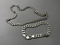 A silver curb bracelet together with a silver necklace. (2) CONDITION REPORT: 81.9g.