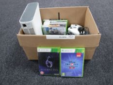 A box containing Xbox 360 with leads controller and games
