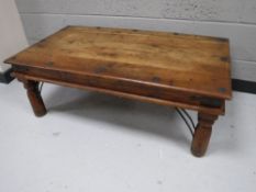 A Mexican pine coffee table with metal mounts