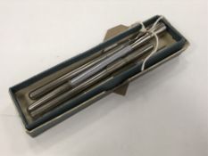 Four early twentieth century thermometers contained in tubes.