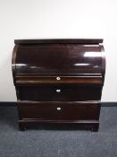 A continental mahogany barrel-fronted bureau