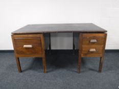 A mid 20th century twin pedestal desk
