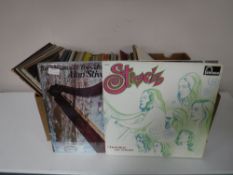 A box containing vinyl LP's; Rock etc including Tom Petty, Bob Dylan,